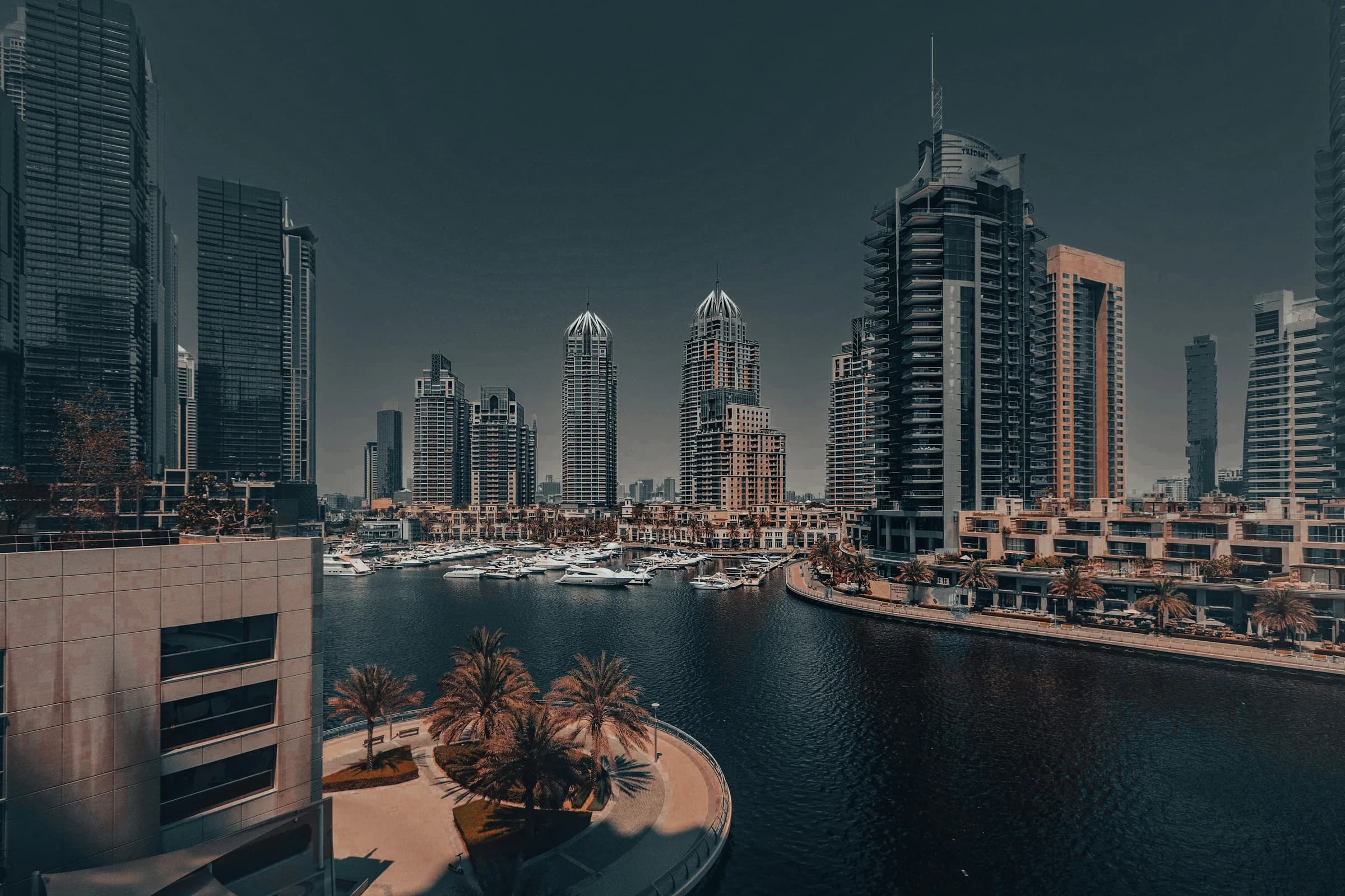 Dubai Marina: residential towers, moored yachts and a palm-lined promenade.